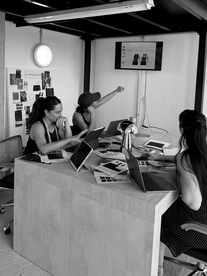 Luisa working with a product team around a table